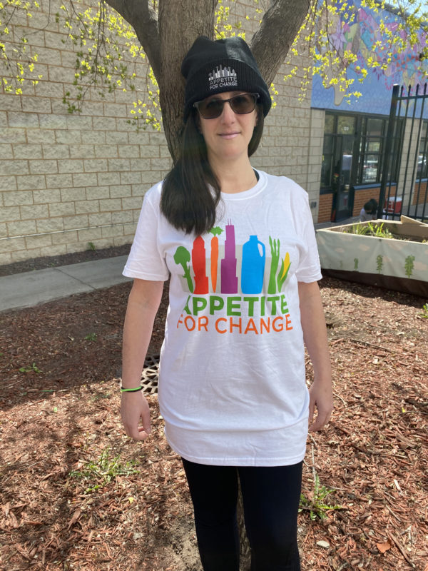 Woman wearing white Appetite For Change tshirt